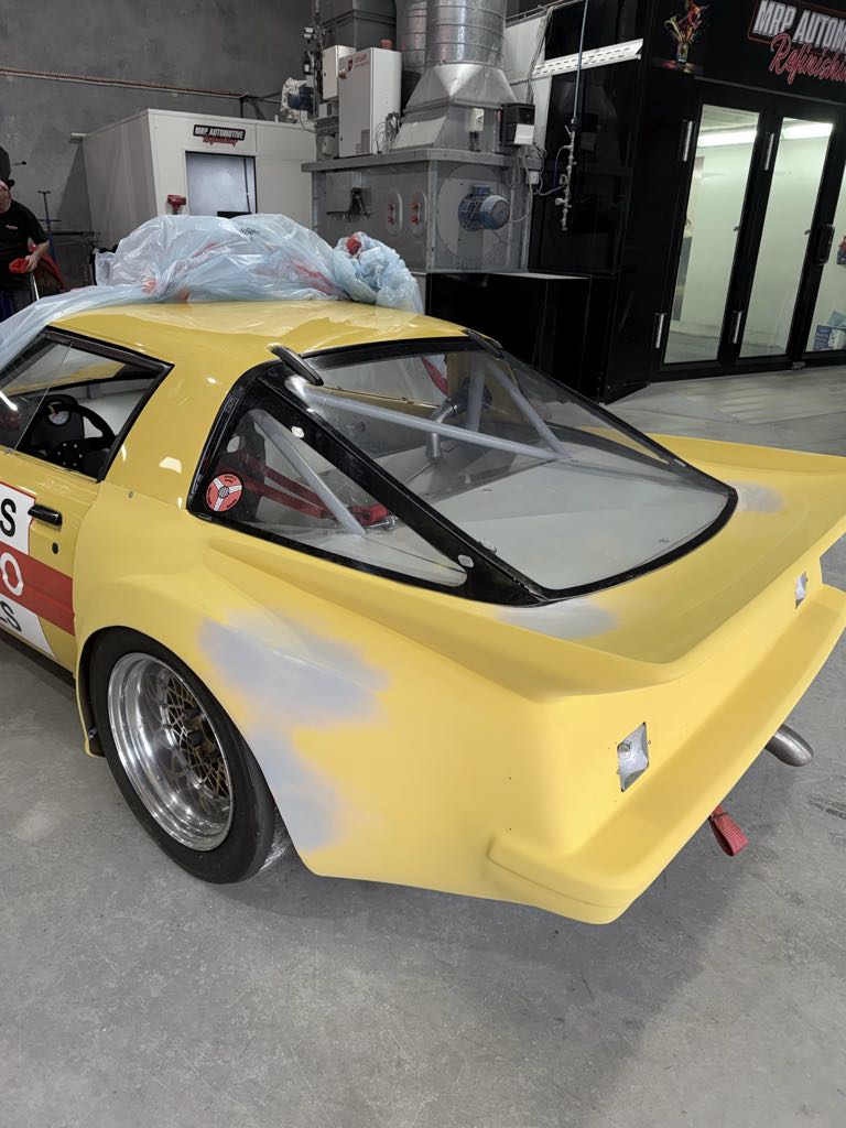 Historic RX-7 race car in primer during body restoration at MRP Automotive Redland Bay